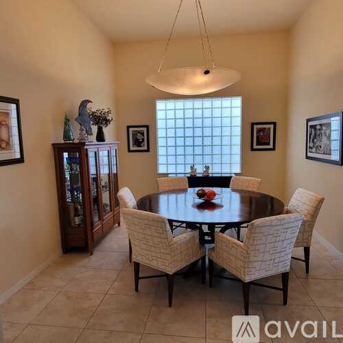 A dining room with a table set for four.