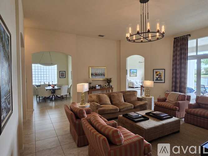 A living room with white couches and a coffee table.