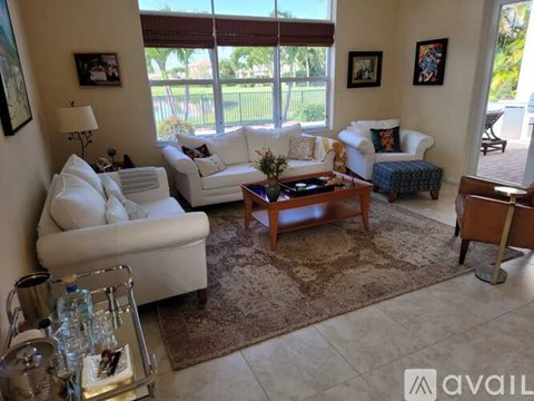 A living room with white couches and a coffee table.