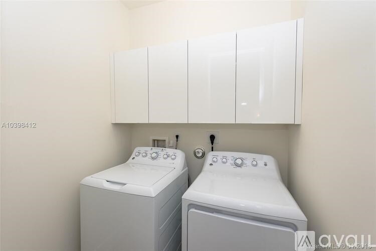 A small bathroom with a washer and dryer.