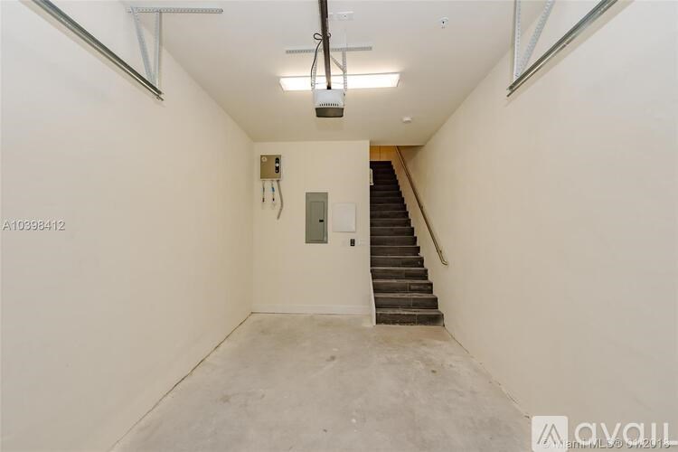 A room with a staircase and a light fixture on the ceiling.