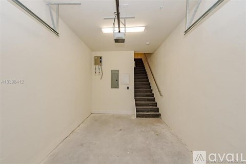 A room with a staircase and a light fixture on the ceiling.