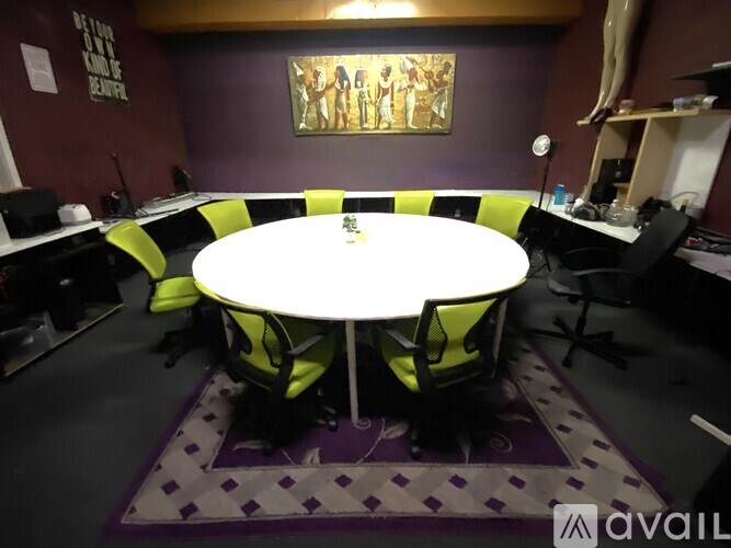 A round table with four chairs around it in a room.