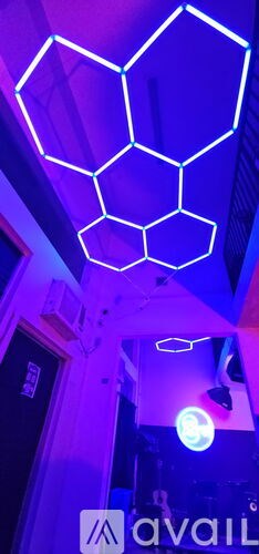 A neon sign in the shape of a hexagon is lit up.