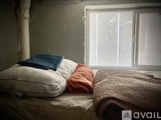 A bed with a blue blanket on top of it.