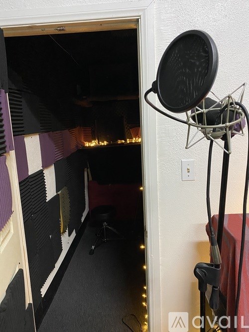 A microphone on a stand in a room.