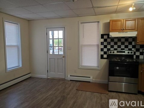 A kitchen with a checkered backsplash and a stove top oven.