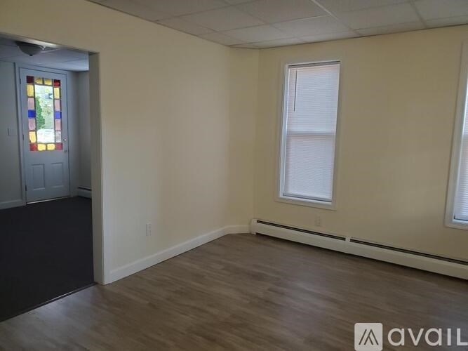 A room with a stained glass window and a door.