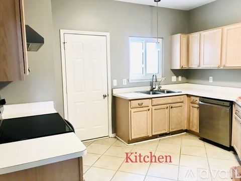 A kitchen with wooden cabinets and a white door.