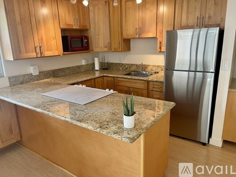 A kitchen with wooden cabinets and granite countertops.