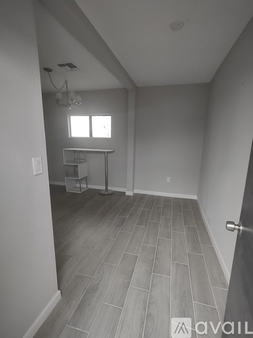A room with a tile floor and a chandelier.