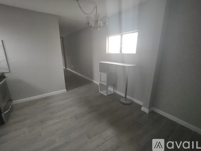 A room with a grey floor and a window.