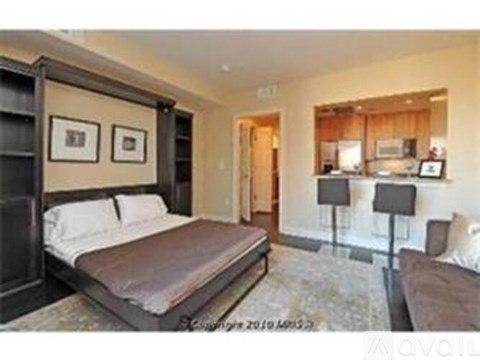 A bedroom with a large bed and a couch.