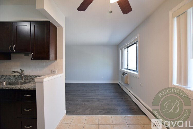 A kitchen with dark brown cabinets and a white countertop.