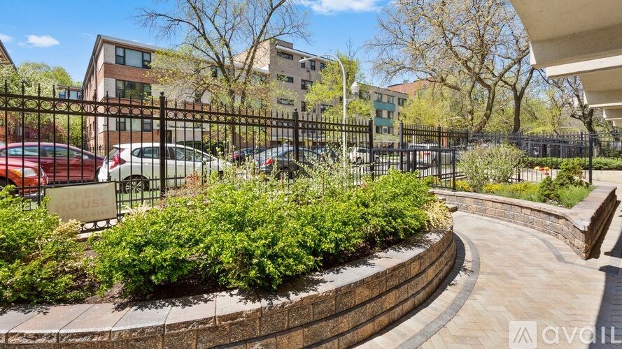 A gated parking lot with a sign that says "LOUIS" on it.