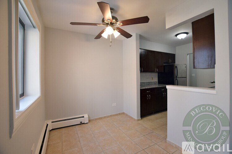 A room with a ceiling fan and a window.