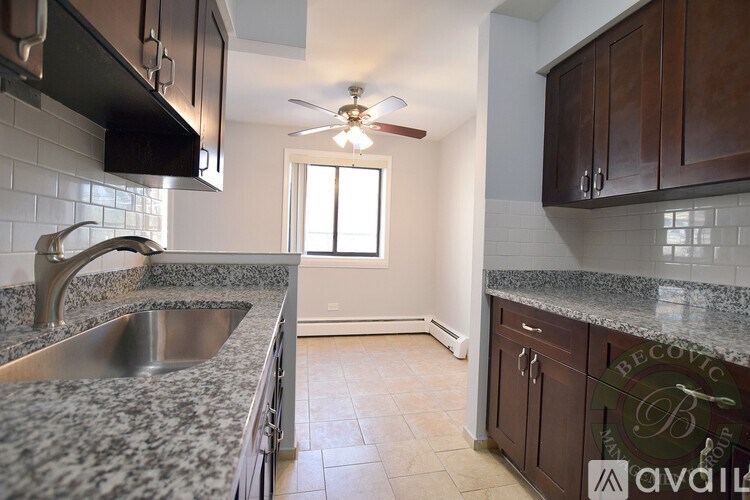 A kitchen with granite countertops and a stainless steel sink.