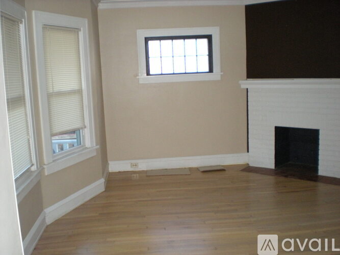 A room with a fireplace and a window.