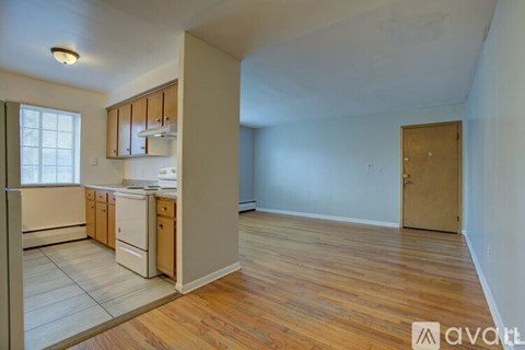 A kitchen with wooden floors and white appliances.