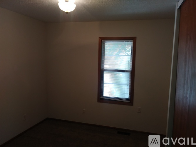 A room with a window and a light on.