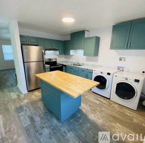 A kitchen with a wooden island in the middle of it.