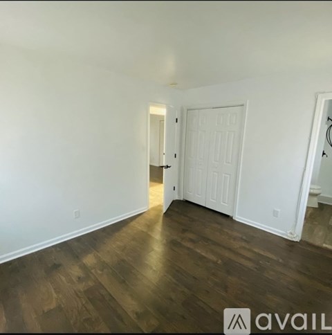 A room with wooden floors and a white door.