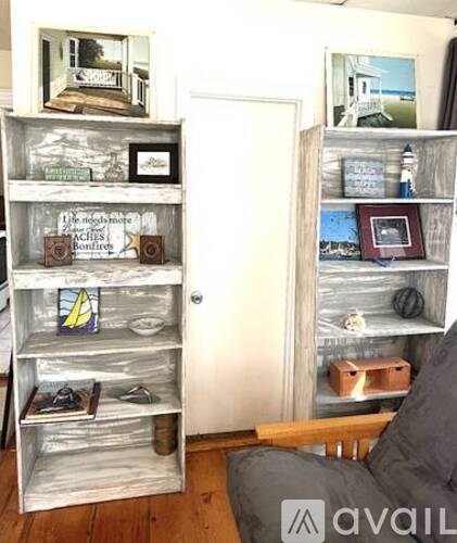 A shelf with a picture of a house on it.