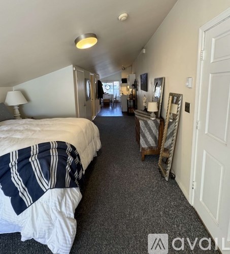 A bedroom with a bed and a dresser with a mirror.