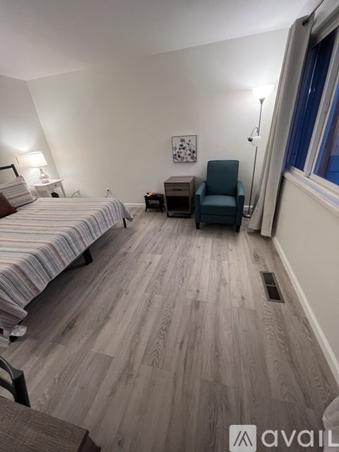 A bedroom with two beds and a desk.