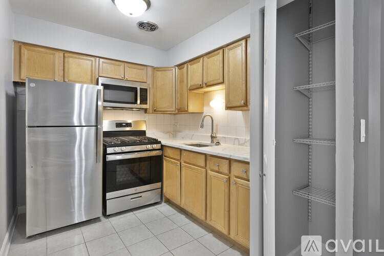 A kitchen with wooden cabinets and stainless steel appliances.