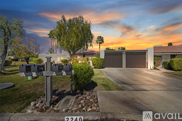 A house numbered 2240 with a driveway and a mailbox.