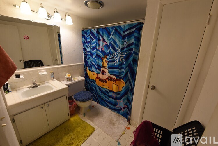 A bathroom with a shower curtain featuring a cartoon character.
