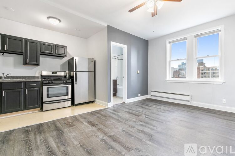 A spacious kitchen with a refrigerator, oven, and microwave.