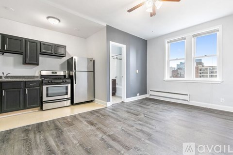 A spacious kitchen with a refrigerator, oven, and microwave.