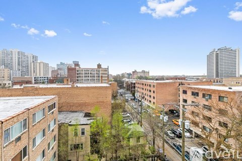 A view of a cityscape with buildings and cars.
