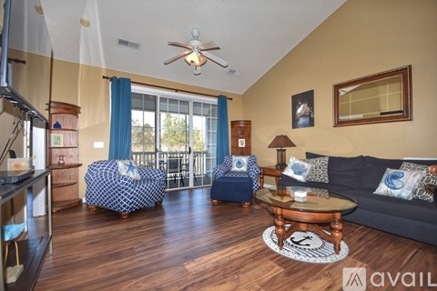 A living room with a blue sofa and a wooden coffee table.