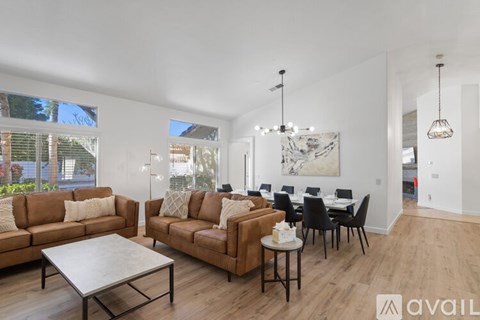 A living room with brown couches and a white coffee table.
