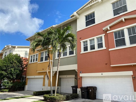 A house with a palm tree in front of it.