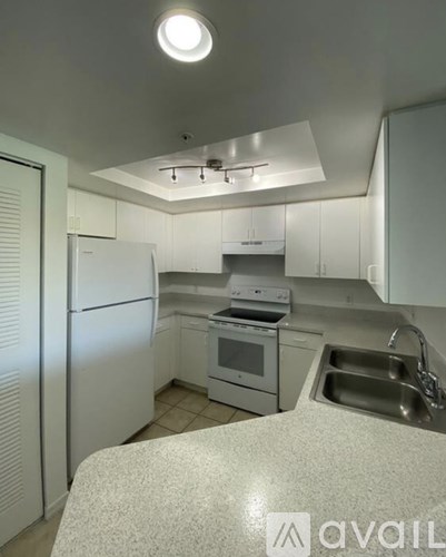 A kitchen with white appliances and cabinets.
