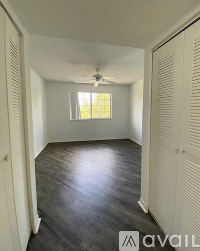 A room with a window and a ceiling fan.