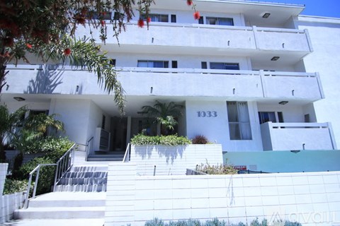 A white building with the number 1033 on the front.