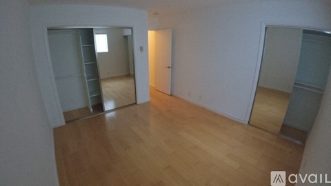 A room with wooden floors and white walls.