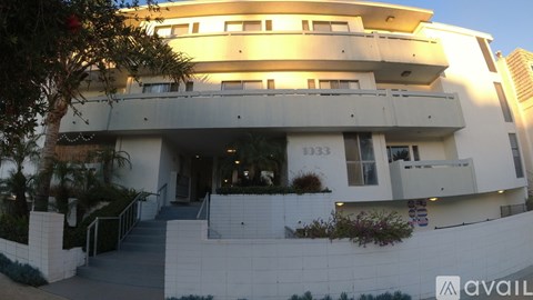 A modern building with a staircase leading to the entrance.