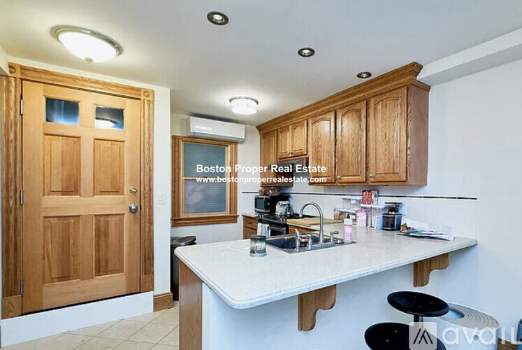 A kitchen with wooden cabinets and a white countertop.