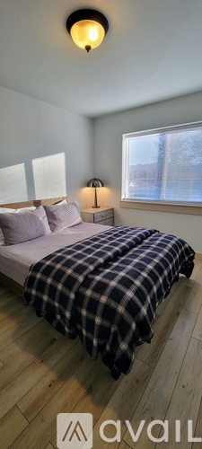A bedroom with a bed and a window.