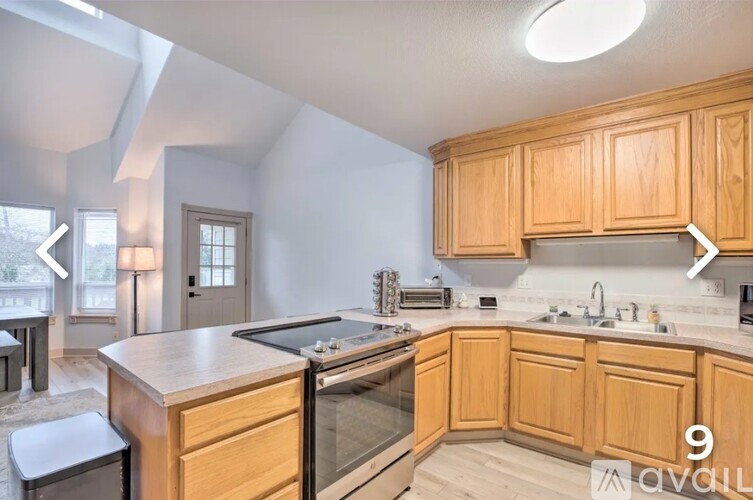 A kitchen with wooden cabinets and a stainless steel oven.