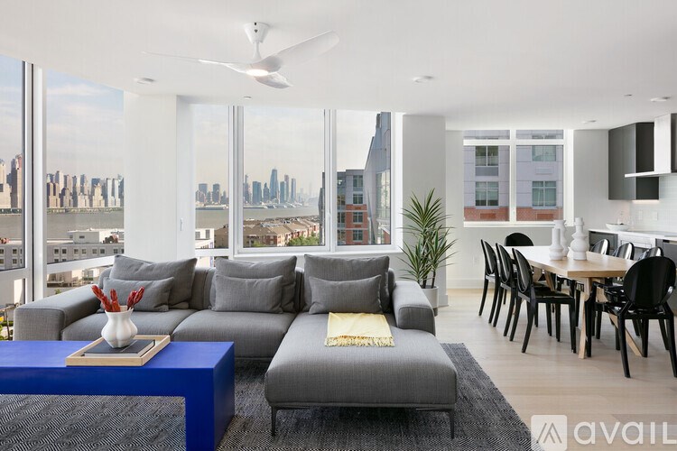 A modern living room with a view of the city skyline.