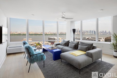 A living room with a grey couch and a blue table.