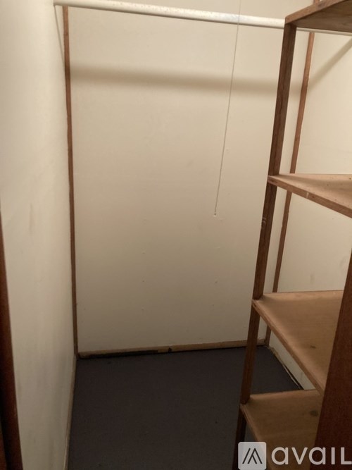 A wooden staircase with a white wall in the background.