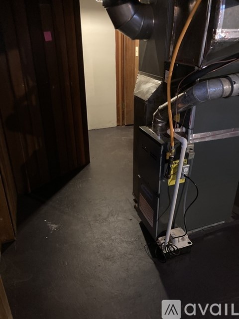 A large industrial machine with a hose coming out of it.